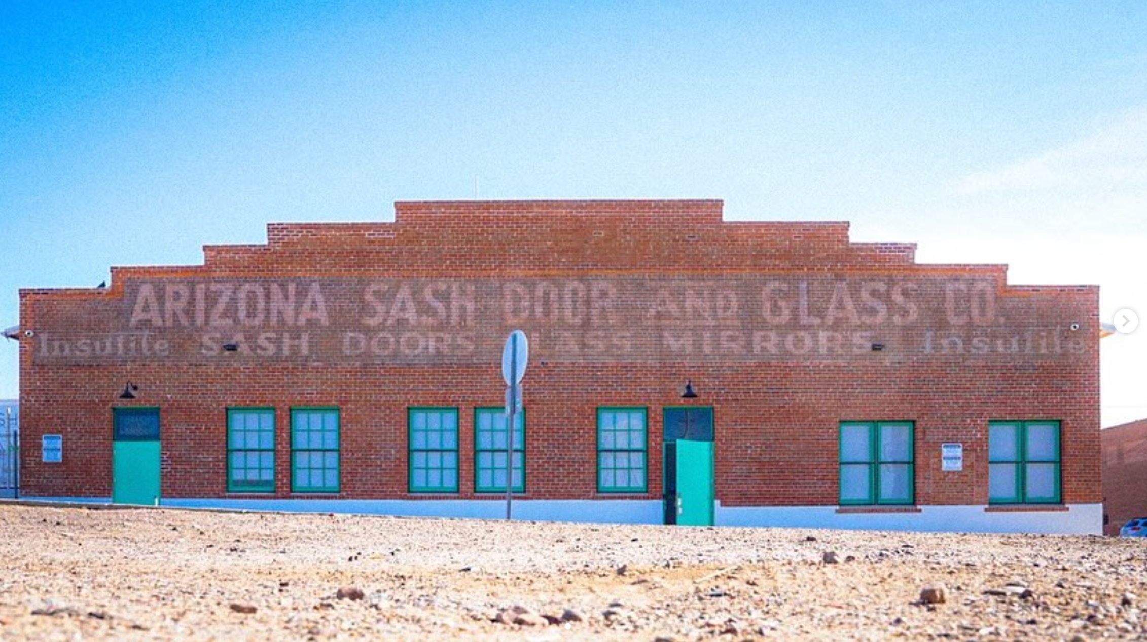 Faded Arizona Sash, Door and Glass Co. ghost sign on the brick facade